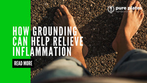 Person standing barefoot on bare ground, symbolizing grounding and connecting with nature."